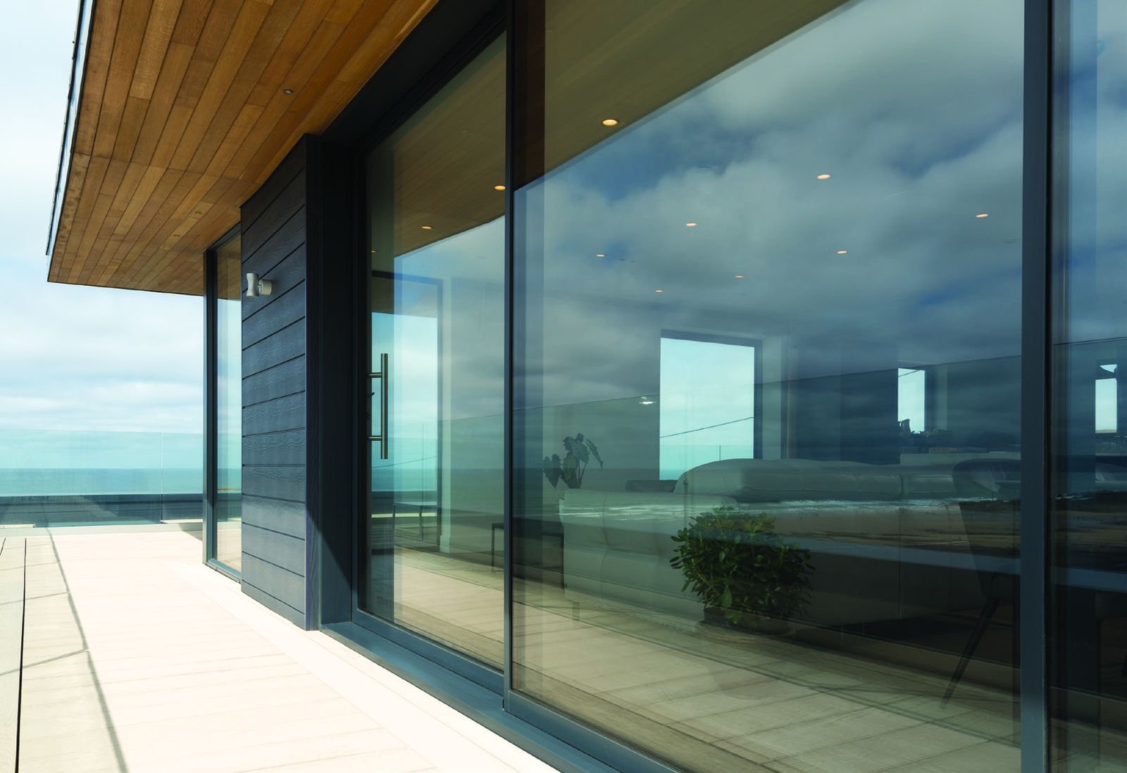 Origin sliding doors on a coastal home at dusk