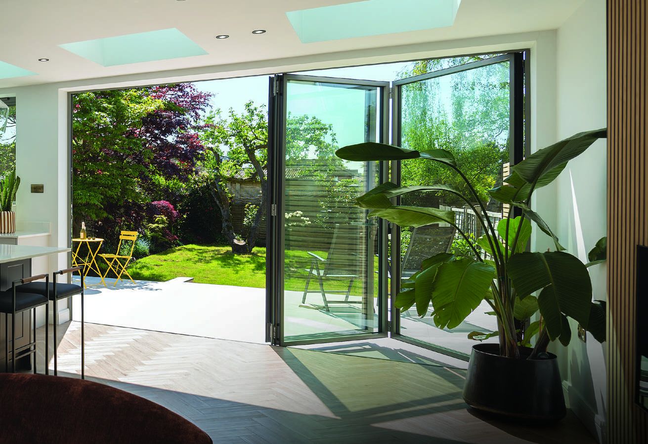Gallery style: slim-framed bifold doors opening onto a garden patio